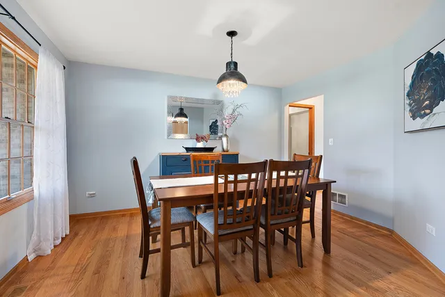 a view of a dining room with furniture window and wooden floor