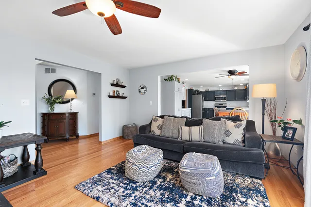 a living room with furniture and a wooden floor