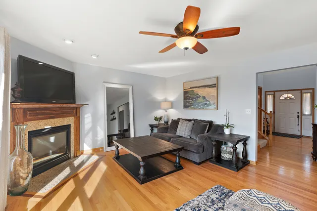 a living room with furniture a flat screen tv and a fireplace