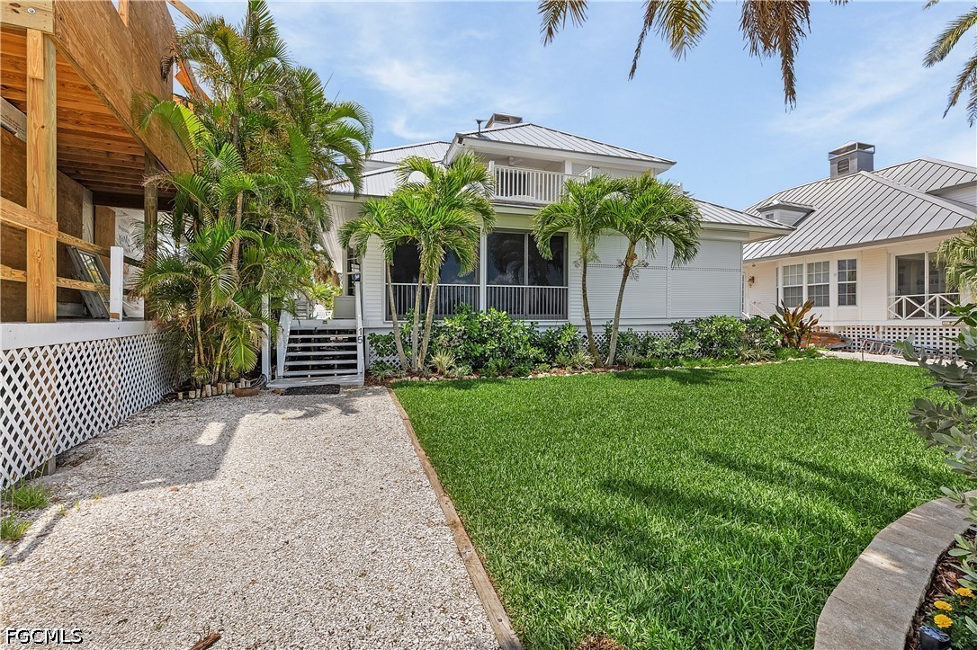 515 Useppa Useppa Island Bokeelia, FL 33922 - Photo 39 of 43 a front view of a house with garden