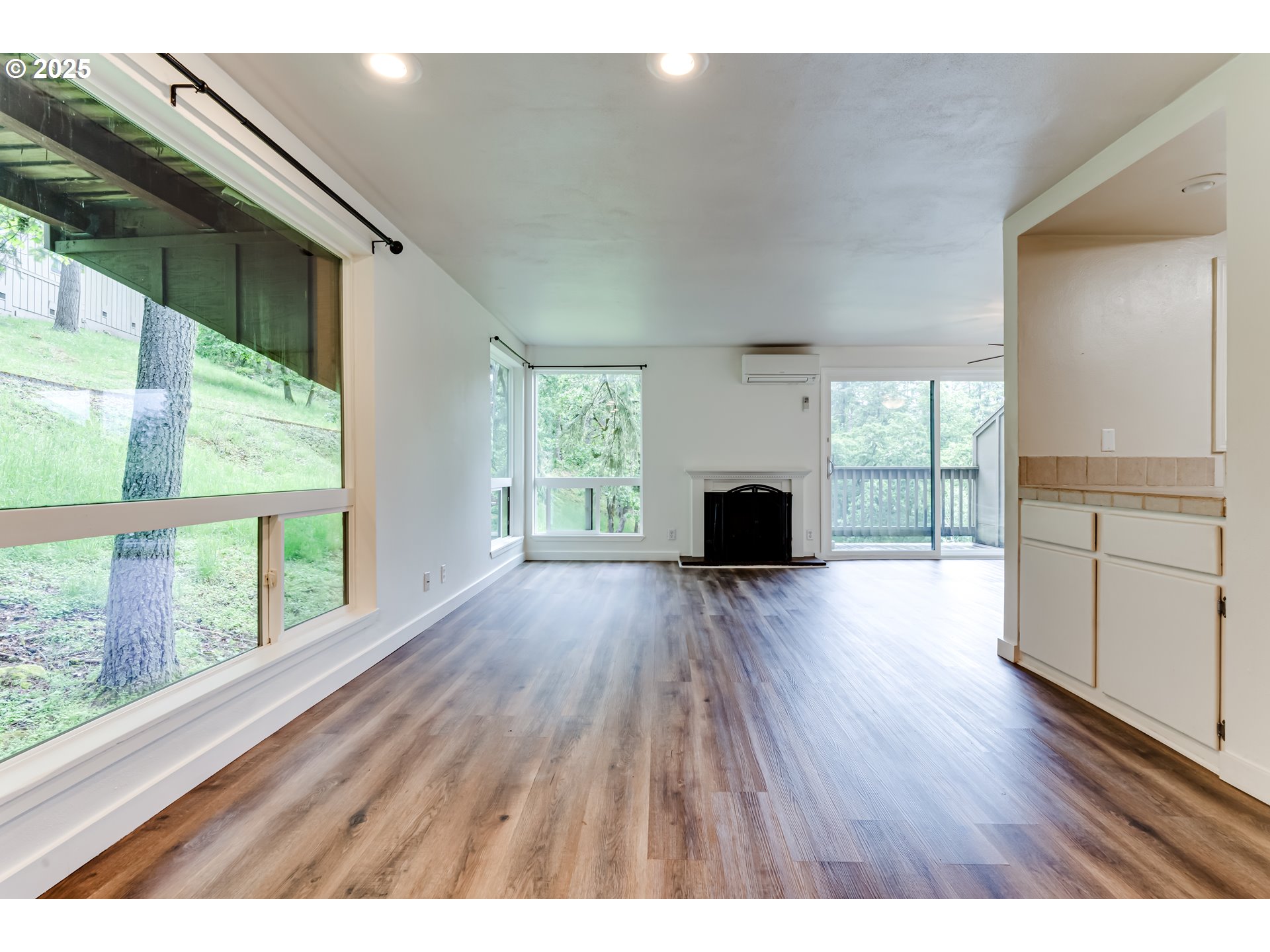 418 Stonewood Drive Eugene, OR 97405 - Photo 3 of 36 a open kitchen with wooden floors and a fireplace