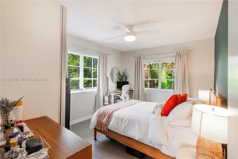 a bed sitting in a bedroom next to a window