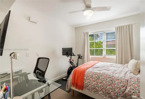 a bedroom with a bed a desk and chair