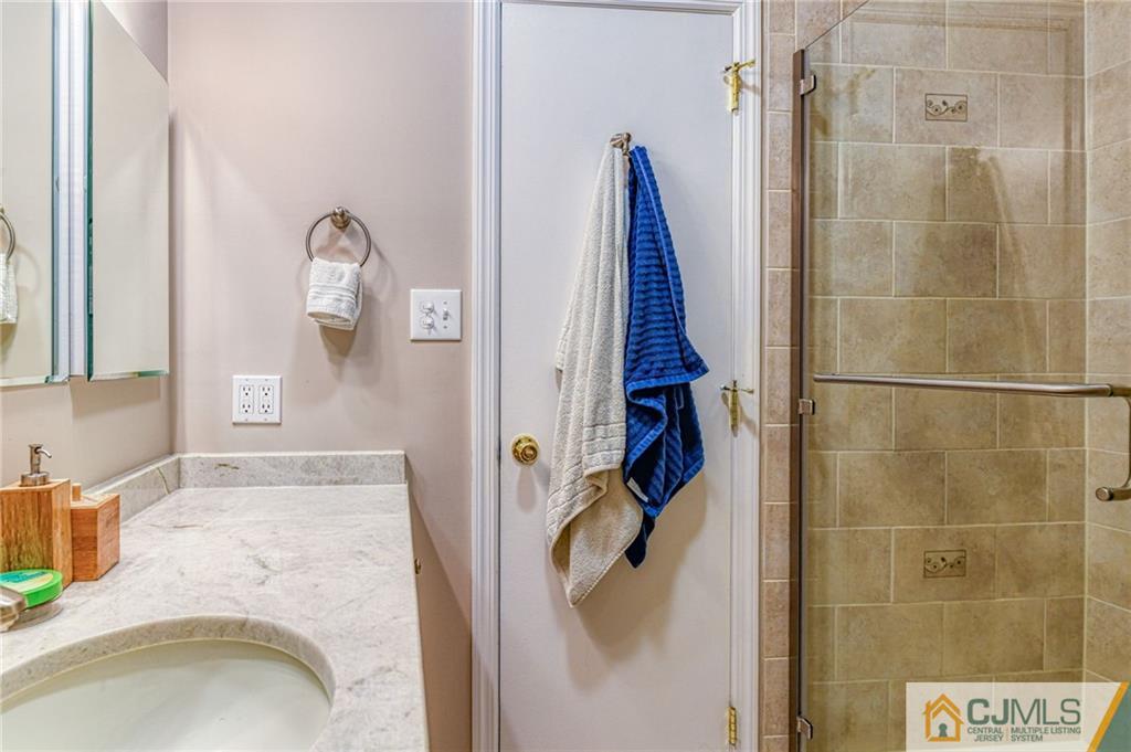 3 Spruce Lane Princeton, NJ 08540 - Photo 21 of 34 a bathroom with a granite countertop shower and a sink