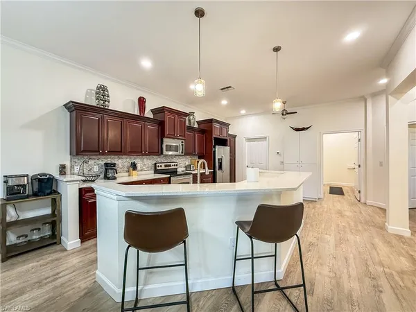 a large kitchen with lots of counter space furniture and appliances