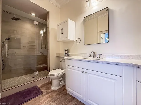 a bathroom with a sink toilet and shower