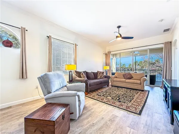 a living room with furniture rug and window