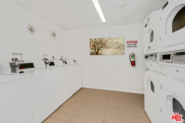 a utility room with multiple dryer and washer