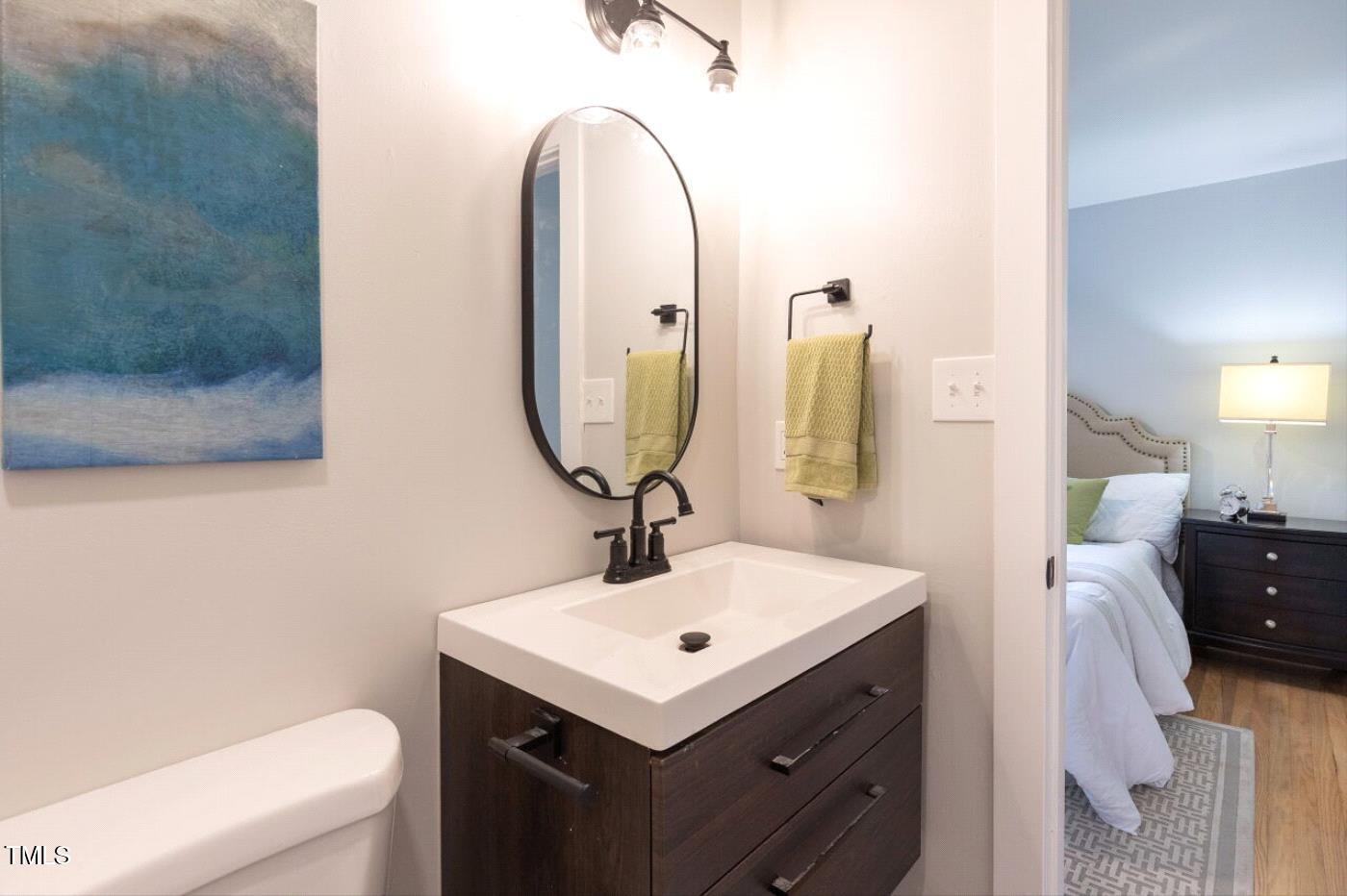410 Fenton Street Raleigh, NC 27604 - Photo 18 of 28 a bathroom with a sink toilet and a mirror