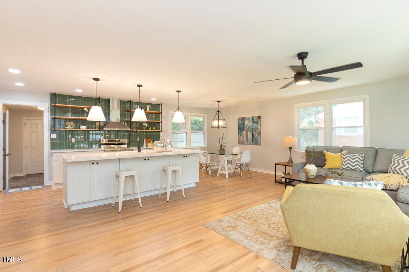 410 Fenton Street Raleigh, NC 27604 - Photo 7 of 28 a living room with kitchen island furniture and a stove