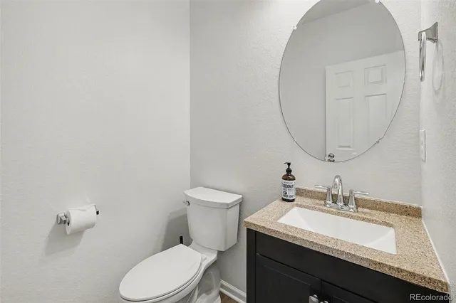a bathroom with a sink toilet and a mirror