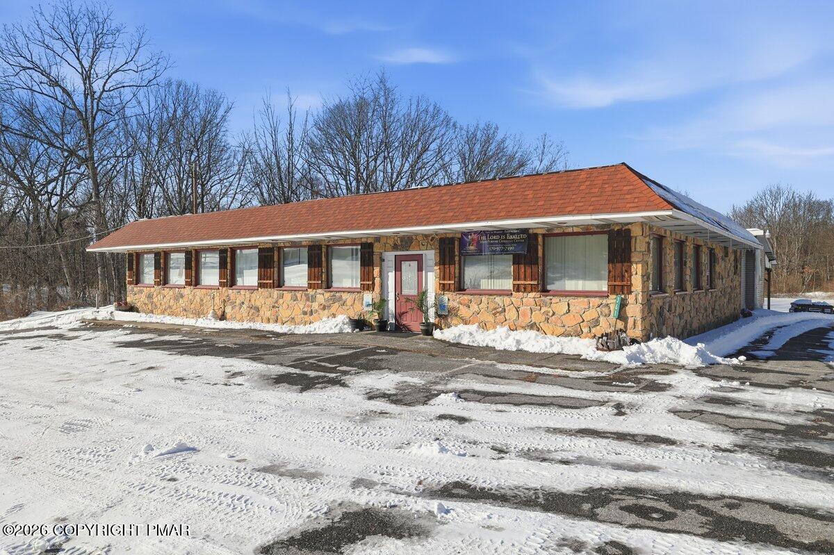361 Interchange Road Kresgeville, PA 18333 - Photo 1 of 48 a view of a white house with a large windows and a big yard