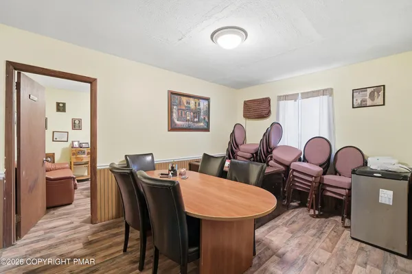 a dining room with furniture a wooden floor and a chandelier