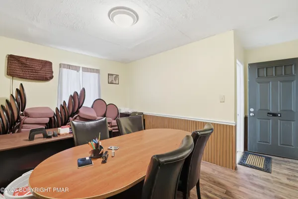 a living room with furniture a flat screen tv and a window