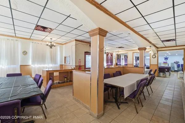 a view of a dining room with furniture and a chandelier