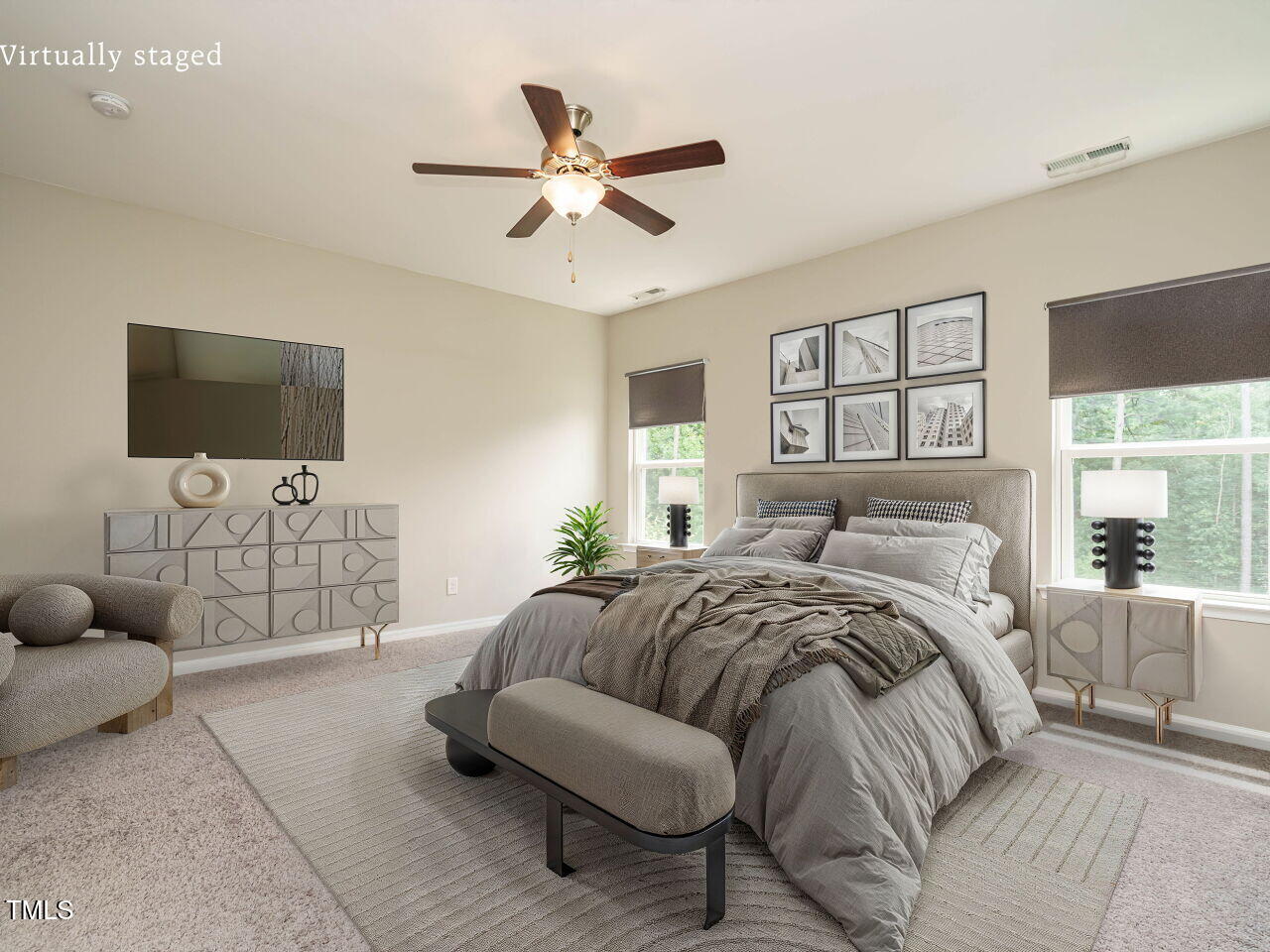 6333 Grace Lily Drive Raleigh, NC 27607 - Photo 13 of 26 a spacious bedroom with a bed a couch and a flat screen tv