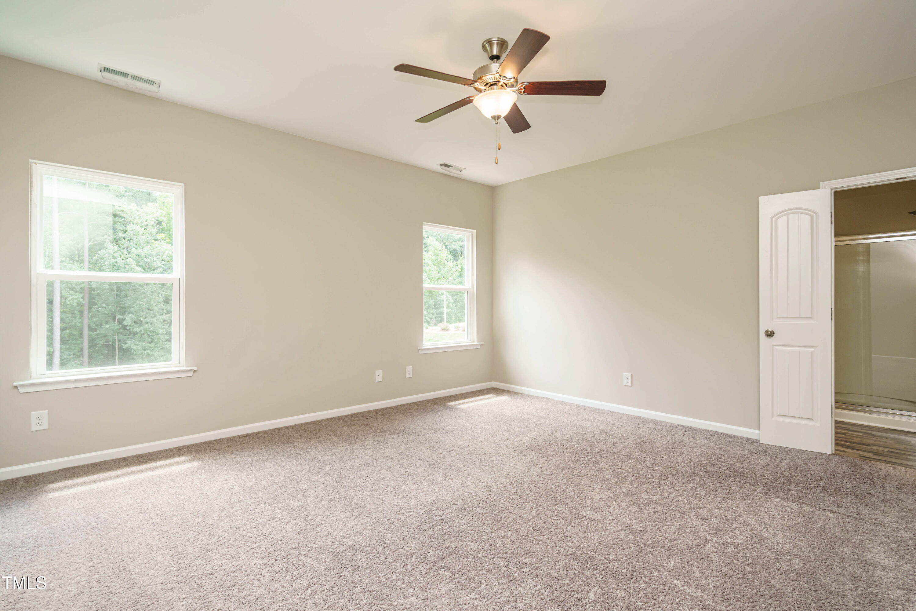 6333 Grace Lily Drive Raleigh, NC 27607 - Photo 15 of 26 an empty room with a window and a fan