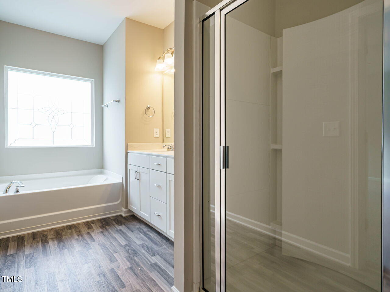 6333 Grace Lily Drive Raleigh, NC 27607 - Photo 16 of 26 a view of bathroom with bathtub and wooden floor