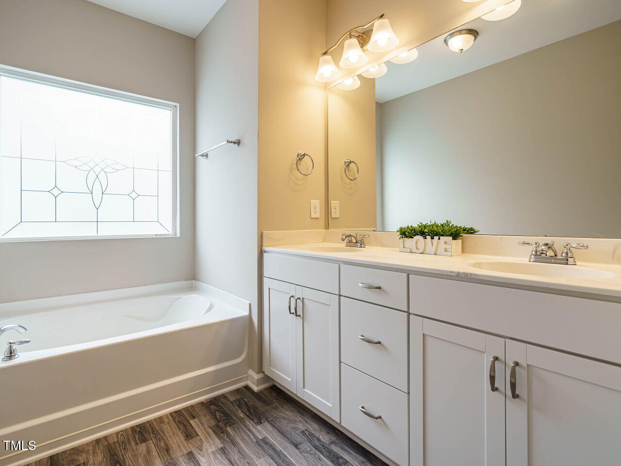 6333 Grace Lily Drive Raleigh, NC 27607 - Photo 17 of 26 a spacious bathroom with a tub sink and mirror