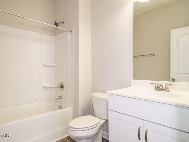 a bathroom with a sink toilet vanity and shower