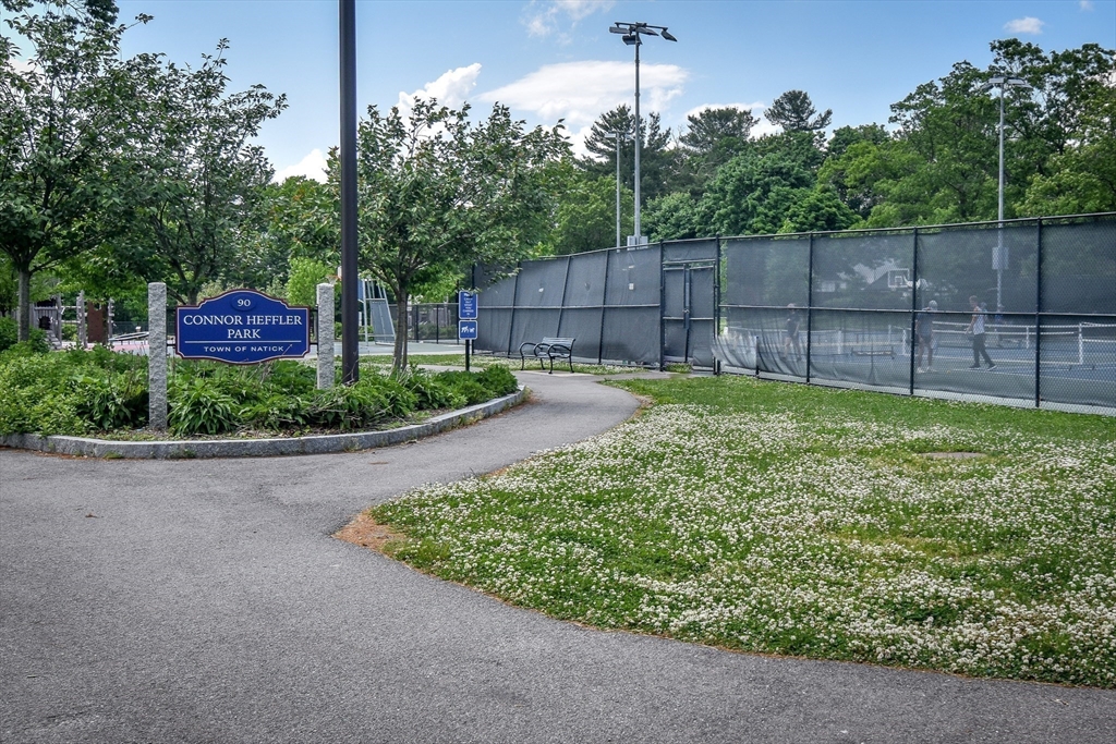 16 Arlington Road Natick, MA 01760 - Photo 23 of 34 a view of a backyard with a fence and trees