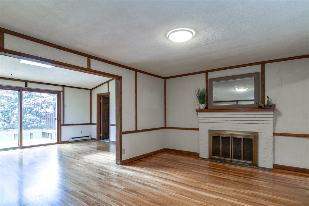 16 Arlington Road Natick, MA 01760 - Photo 4 of 34 a view of empty room with wooden floor and fireplace
