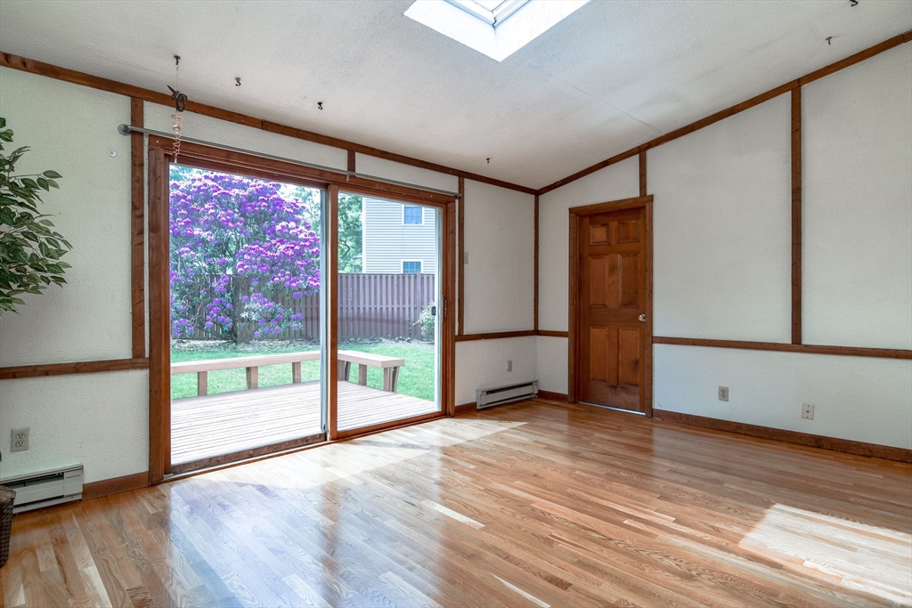 16 Arlington Road Natick, MA 01760 - Photo 5 of 34 a view of an empty room with wooden floor and a window