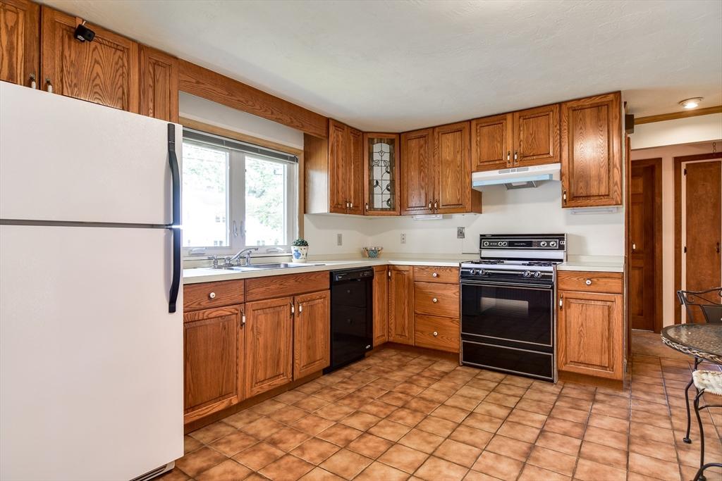 16 Arlington Road Natick, MA 01760 - Photo 8 of 34 a kitchen with granite countertop a refrigerator stove top oven and sink
