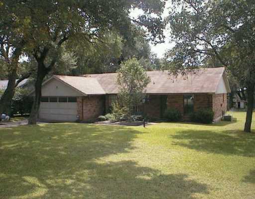 a house that has a tree in front of it