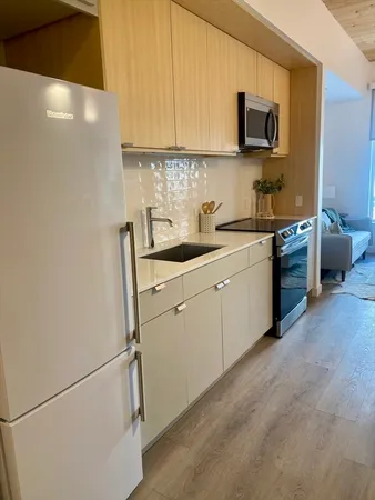 a kitchen with a sink cabinets and appliances