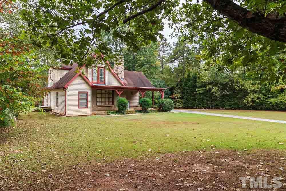 12704 Old Creedmoor Road Raleigh, NC 27613 - Photo 1 of 16 a view of a house with backyard and garden