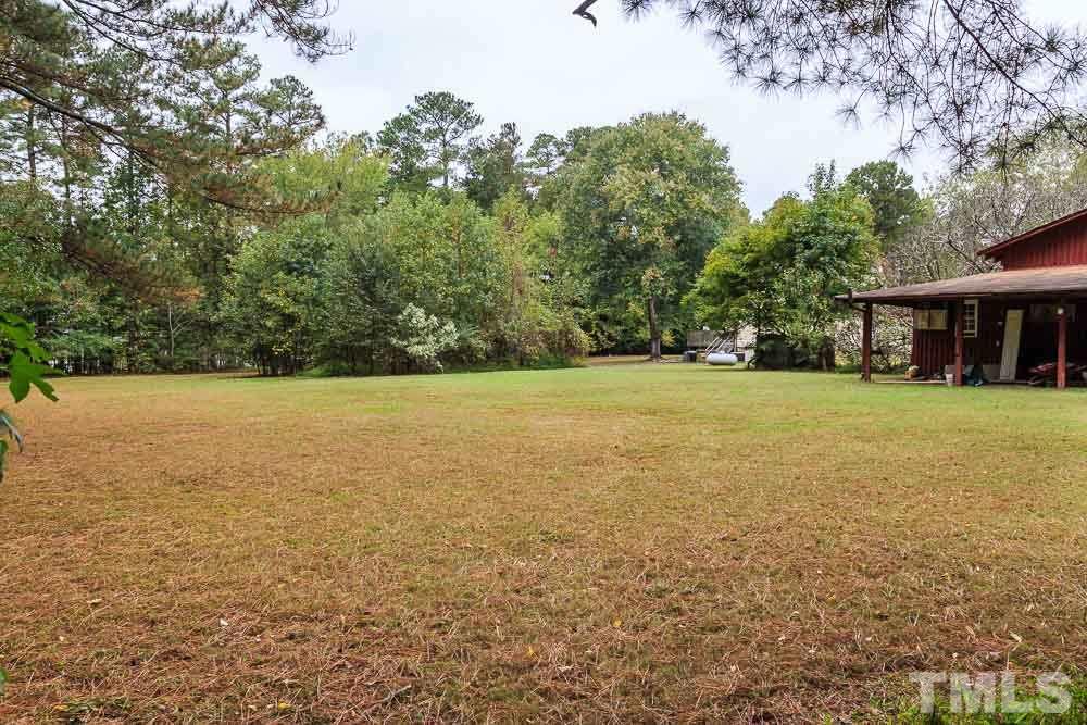 12704 Old Creedmoor Road Raleigh, NC 27613 - Photo 11 of 16 a view of a field with trees in the background