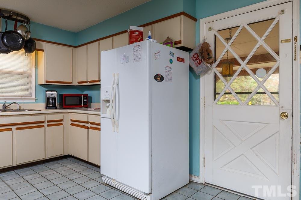 12704 Old Creedmoor Road Raleigh, NC 27613 - Photo 13 of 16 a white refrigerator freezer sitting inside of a kitchen