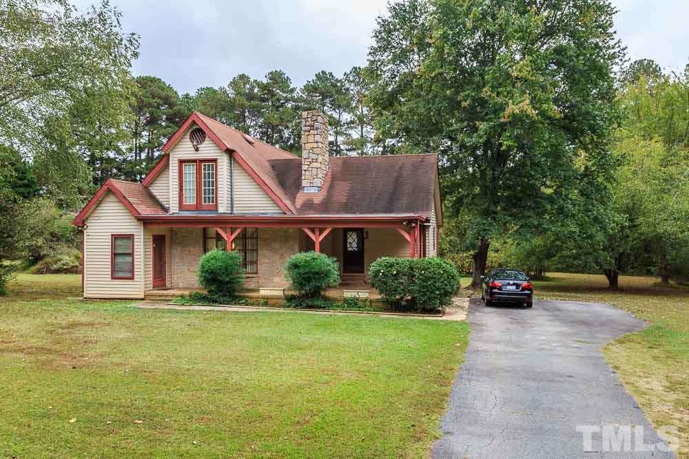 12704 Old Creedmoor Road Raleigh, NC 27613 - Photo 2 of 16 a front view of a house with a yard