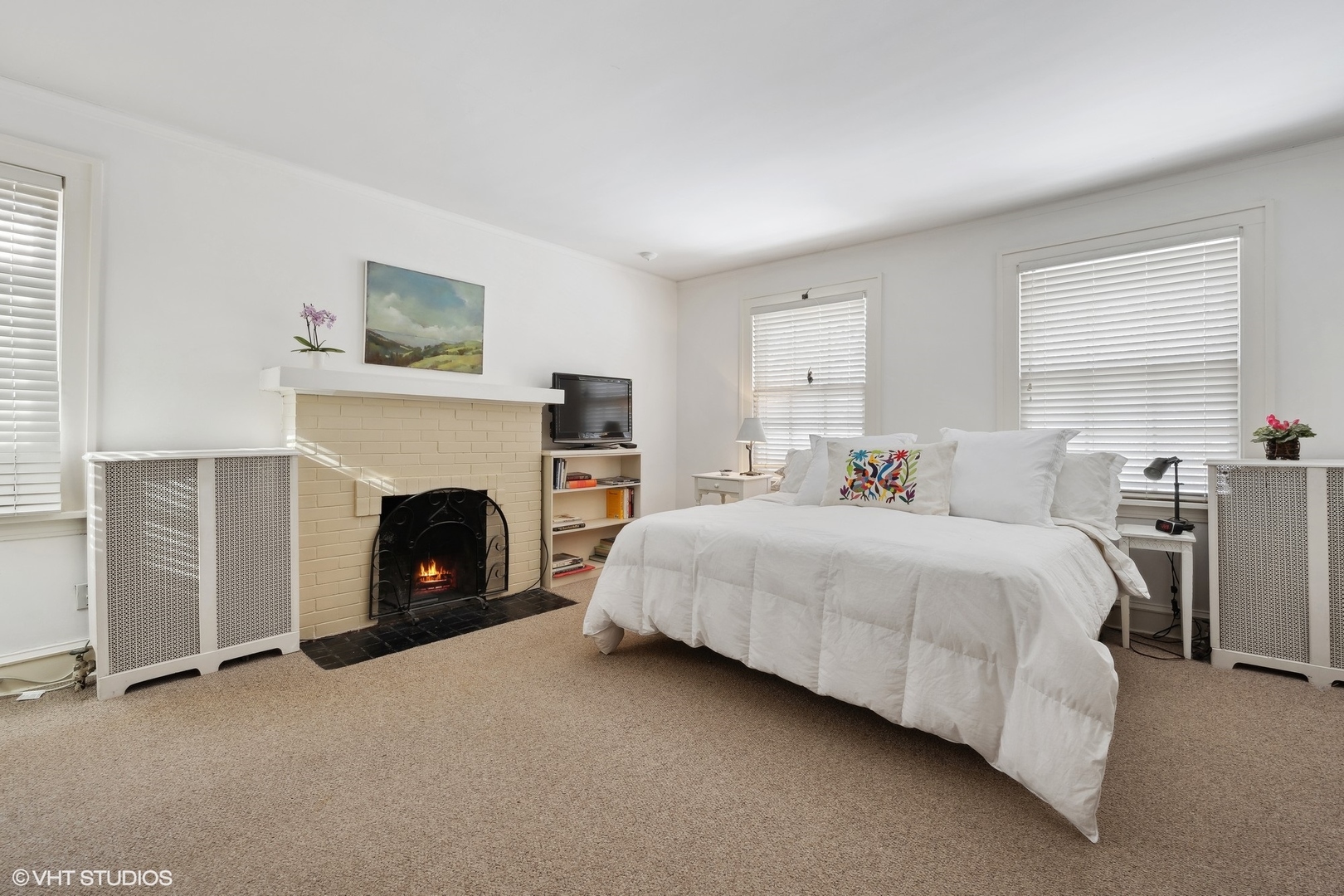 379 Ridge Avenue Winnetka, IL 60093 - Photo 13 of 31 a spacious bedroom with a bed and a fireplace