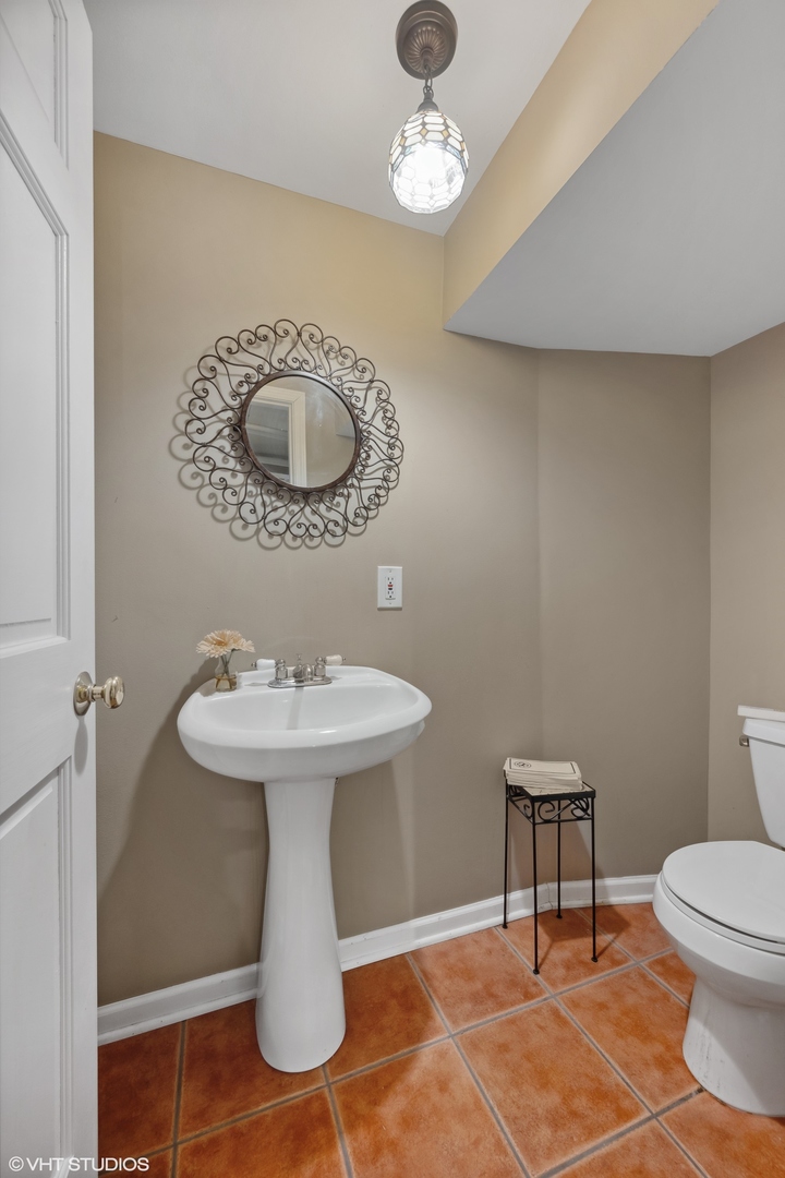 379 Ridge Avenue Winnetka, IL 60093 - Photo 23 of 31 a bathroom with a toilet a sink and a mirror