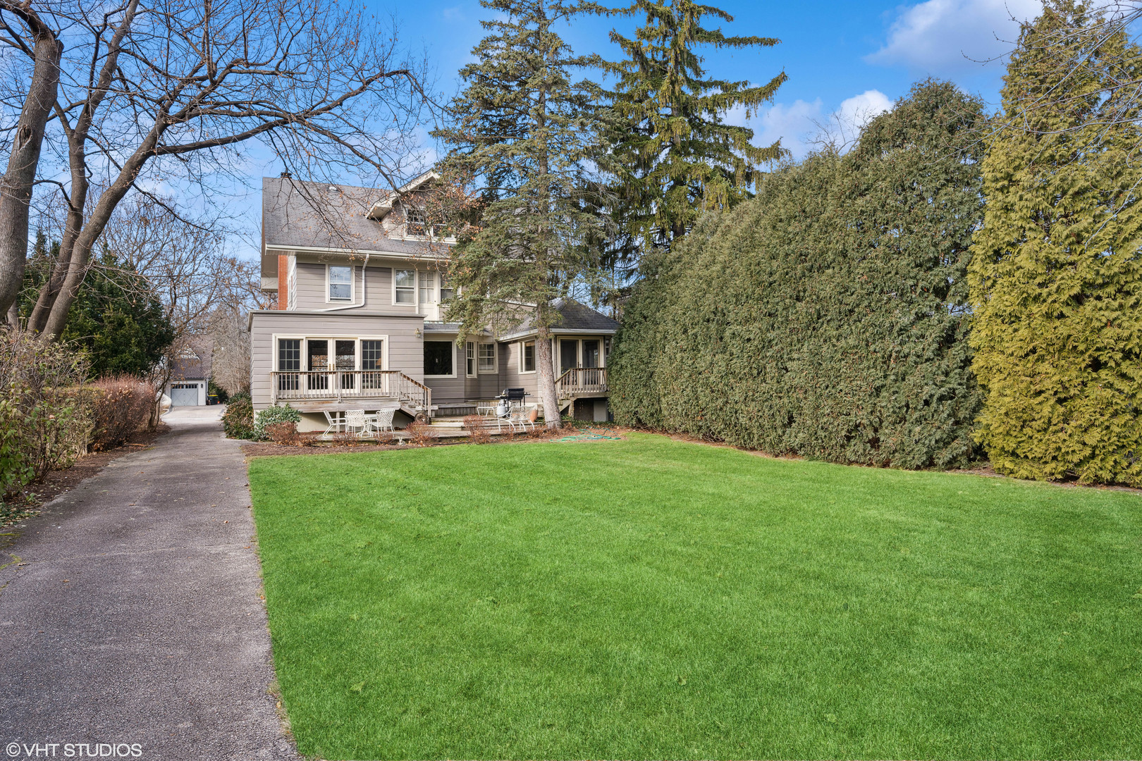 379 Ridge Avenue Winnetka, IL 60093 - Photo 25 of 31 a backyard of a house with yard and outdoor seating