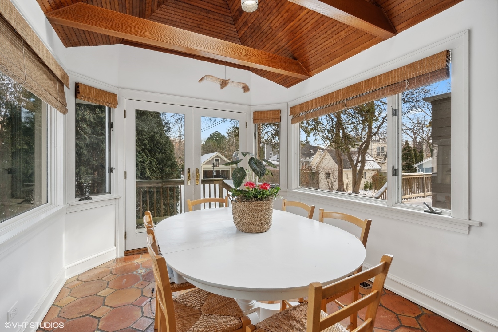 379 Ridge Avenue Winnetka, IL 60093 - Photo 9 of 31 a dining room with furniture a potted plant and floor to ceiling windows