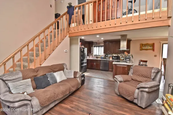 a living room with furniture and a wooden floor