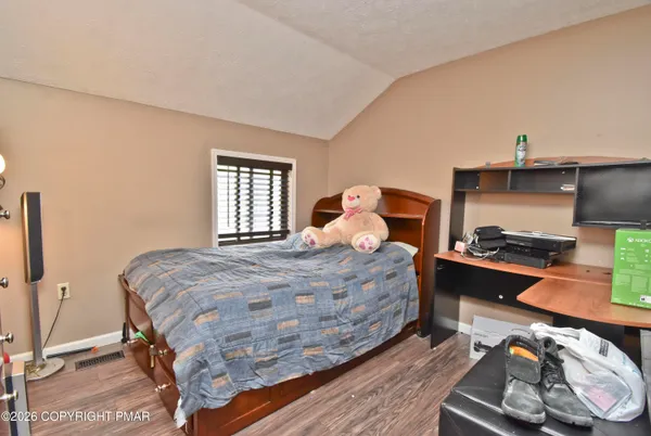 a bedroom with furniture and a wooden floor