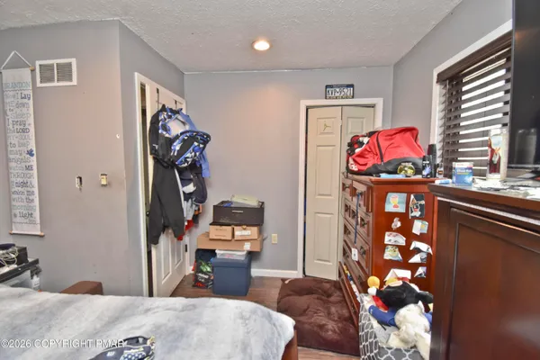 a bedroom with a bed and a table in it