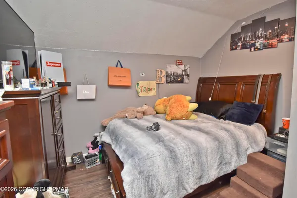 a bathroom with a toilet sink vanity and mirror
