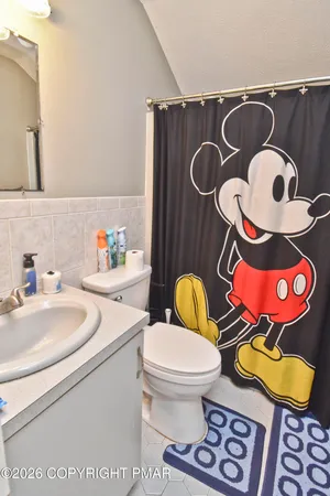 a bathroom with a toilet a sink and a mirror