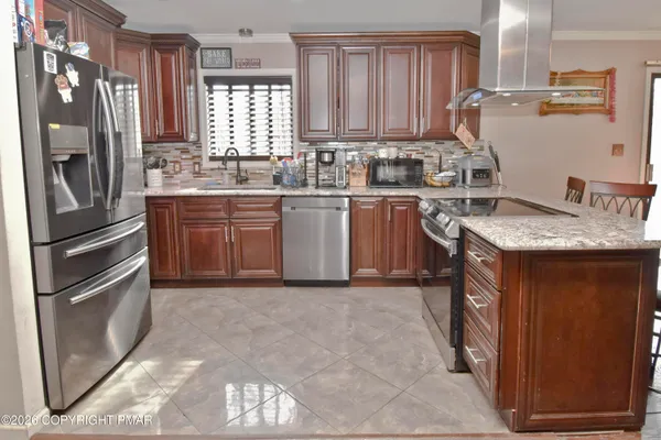 a kitchen with a refrigerator sink and stove