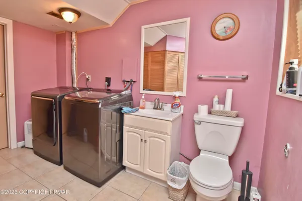 a backyard of a house with barbeque oven table and chairs