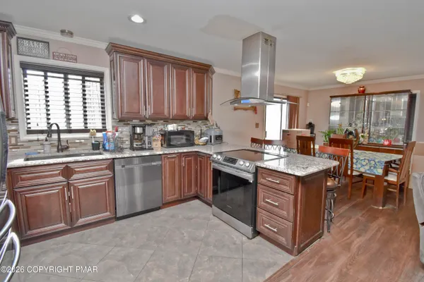 a kitchen with granite countertop a sink stove and cabinets