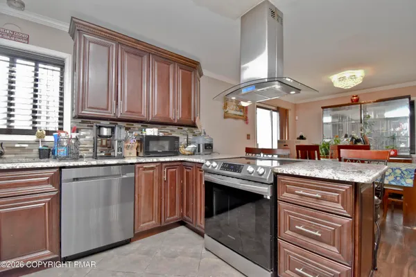 a kitchen with stainless steel appliances granite countertop a sink and a stove