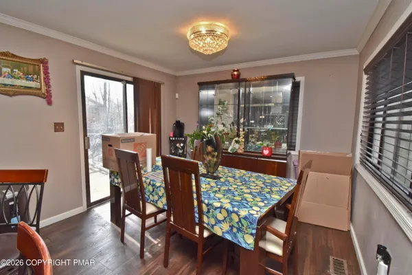a view of a dining room with furniture window and wooden floor