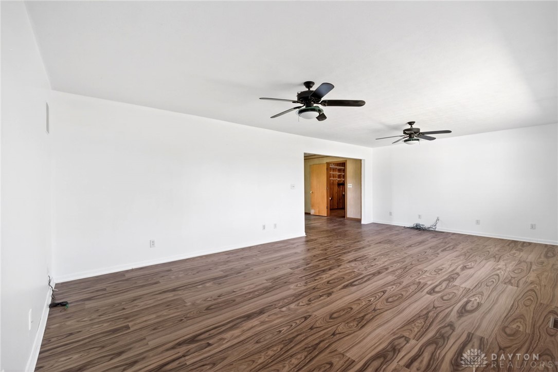 1005 Free Road New Carlisle, OH 45344 - Photo 6 of 43 This expansive living space features durable flooring and bright white walls.