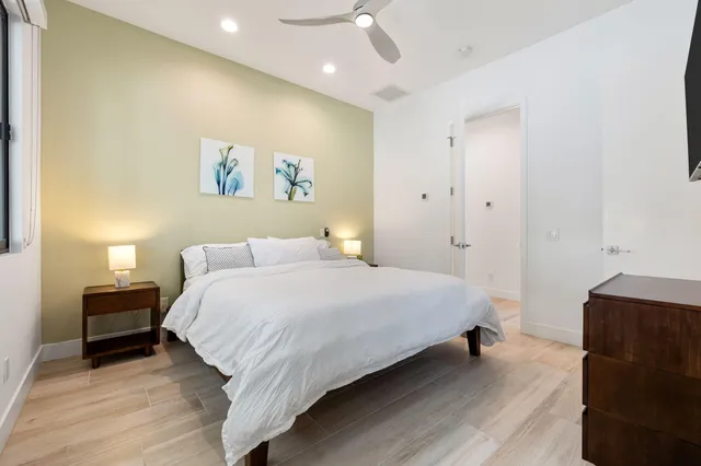 a bedroom with a bed and a flat screen tv